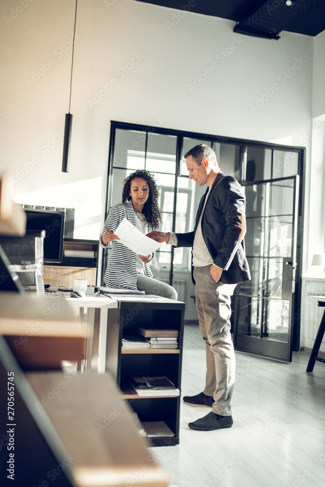 © Viacheslav Yakobchuk - Curly dark-haired trainee of international company talking to CEO