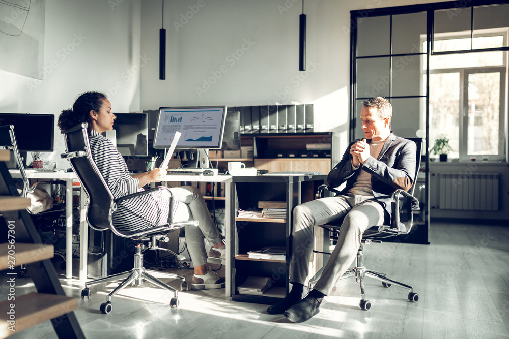 Mature man feeling unsure while having serious job interview