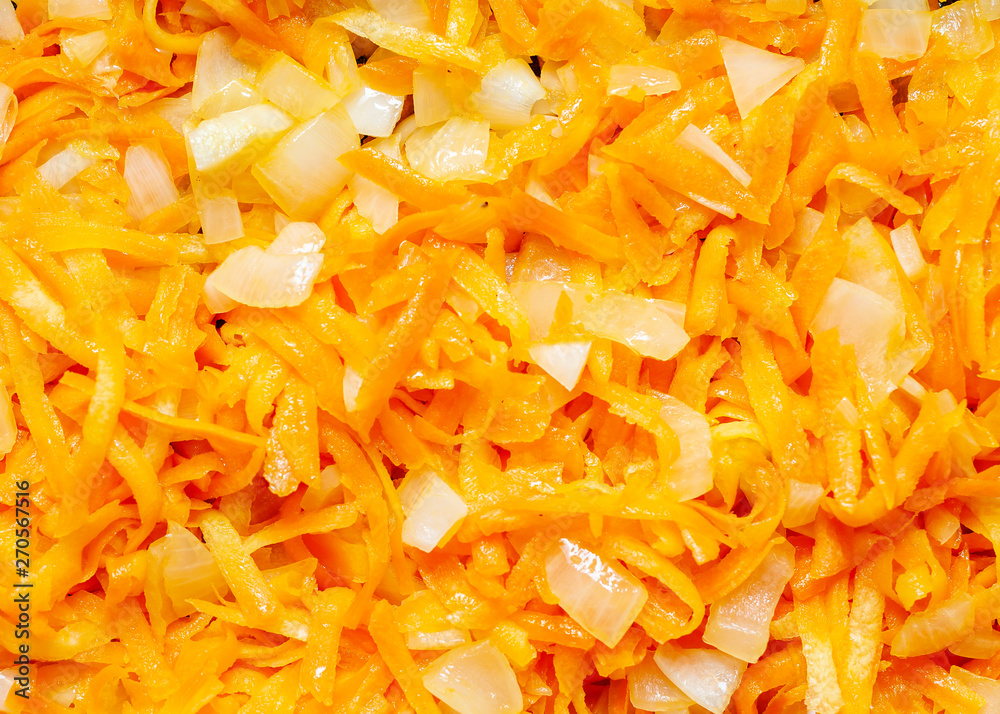 Fresh appetizing carrots finely RUB and fry with onions on a frying pan with oil. Preparation of carrots For garnish. Fresh appetizing carrots finely RUB and fry with onions on a frying pan with oil. Preparation of carrots For garnish.