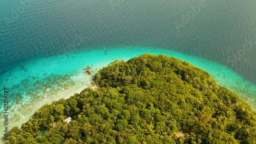 Fototapeta Naklejka Na Ścianę i Meble -  Seascape island coast with forest and palm trees, coral reef with turquoise water, aerial view. Sea water surface in lagoon and coral reef. Coastline of tropical island covered green forest near at