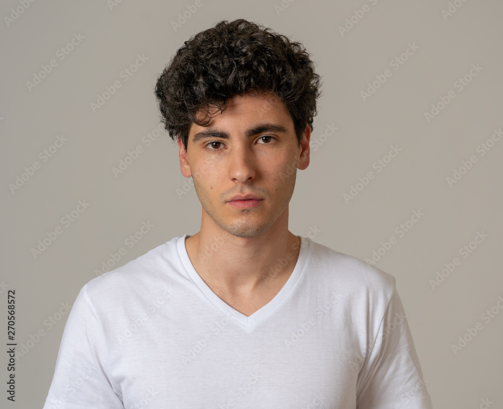 Portrait of handsome young man in neutral poker facial expressions and human emotions Portrait of handsome young man in neutral poker facial expressions and human emotions