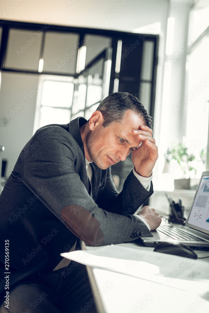 Businessman touching his head while feeling busy of work Businessman touching his head while feeling busy of work