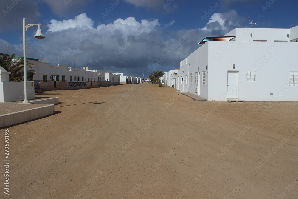 Extreme solitude in the white-walled village of Caleta de Sebo (La Graciosa Island - Lanzarote - Chinijo Archipelago - Canary Islands - Spain) on a March afternoon. Extreme solitude in the white-walled village of Caleta de Sebo (La Graciosa Island - Lanzarote - Chinijo Archipelago - Canary Islands - Spain) on a March afternoon.