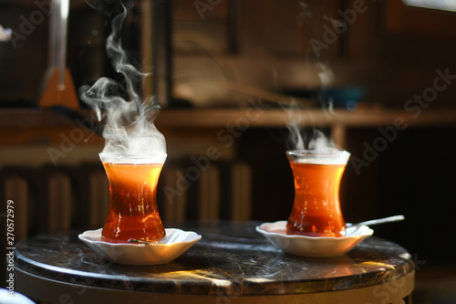 Tea in traditional turkish glass on a table