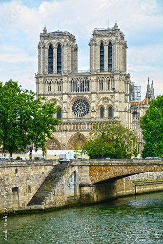 Legendary Paris cathedral Notre Dame. Beautiful Parisian achitecture. Magnificent landmark after destructive fire.Panorama of Seine river with gothic cathedral in view.Paris, France