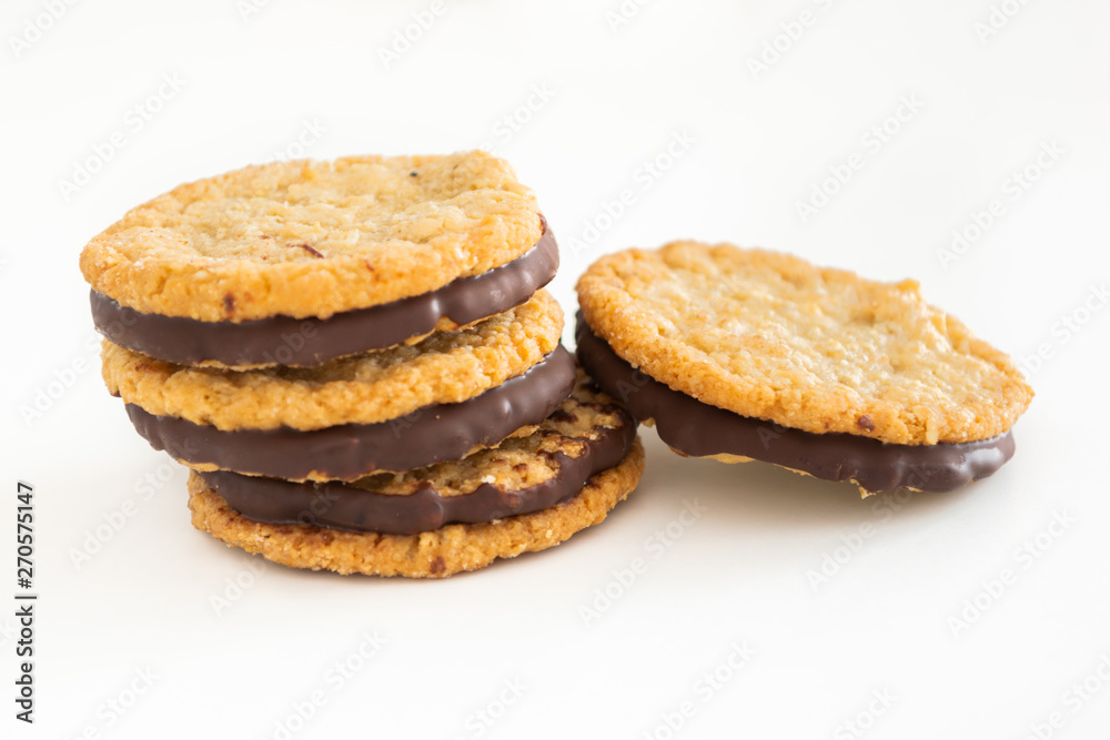 Oatmeal cookies and chocolate on white background Oatmeal cookies and chocolate on white background