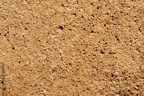Sandy yellow rocky road texture. Natural earth path backdrop.