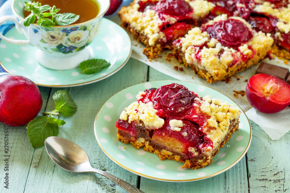 Sweet pie, tart with chocolate and fresh plum. Delicious cake with plum on kitchen table. Sweet pie, tart with chocolate and fresh plum. Delicious cake with plum on kitchen table.
