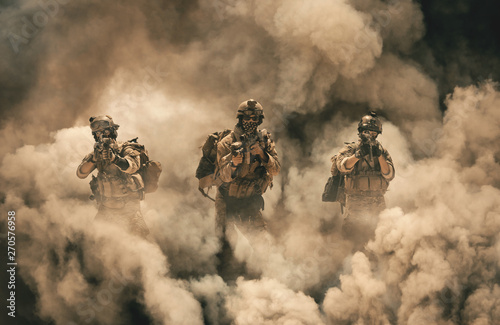 Military soldier between smoke and dust in battlefield photo