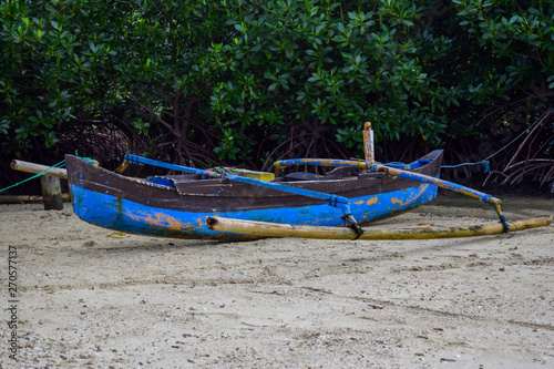 traditional fishing wooden boat near island in indonesia island. © syahrir