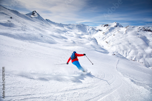 Young attractive skier skiing in famous ski resort in Alps, Livigno, Italy, Europe photo