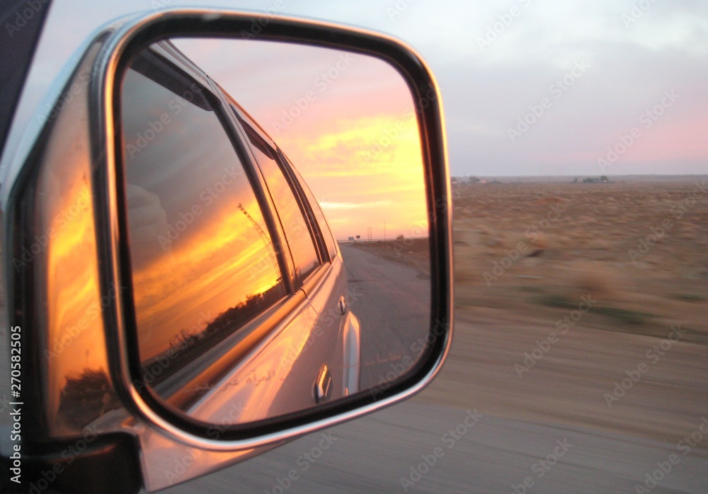 Sunset. Car mirror.