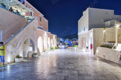 Fototapeta Naklejka Na Ścianę i Meble -  SANTORINI, GREECE - JUNE 2014: Sunset view of Oia buildings and streets. Oia is the major tourist attraction on the island