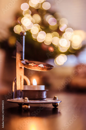 Christmas time: Candle with incense, Christmas tree and presents