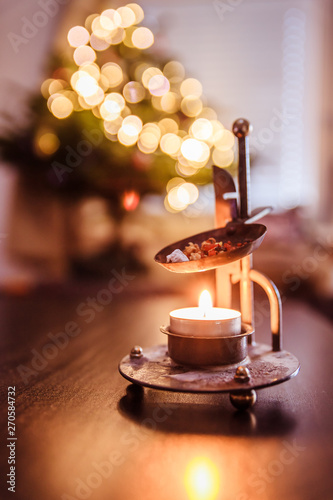 Christmas time: Candle with incense, Christmas tree and presents © Patrick Daxenbichler