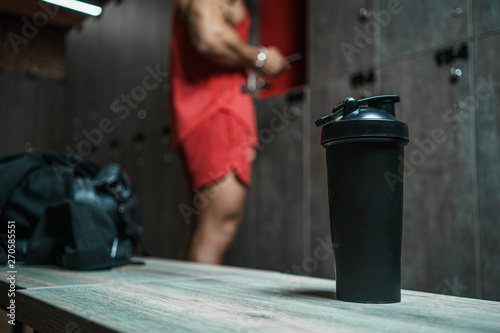 Photography handsome muscular athletic man with a towel in the locker room after working out
