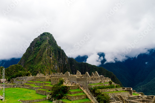 Ruins of Machu Picchu with tourists touring and Wayna Picchu mountain in the background