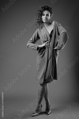 Young beautiful woman with curly hair posing in black and white