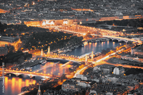 Aerial view of famous bridges in Paris at night. Seine river with traffic lights in Paris, France. © Augustin Lazaroiu
