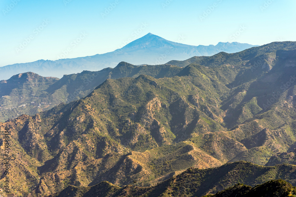 Canyon and jagged mountain range of Vallehermoso what means the beautiful valley in english. In the back, the Pico del Teide on Tenerife
