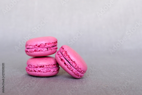 Stack of delicious french purple blueberry macarons on grey background © Iryna