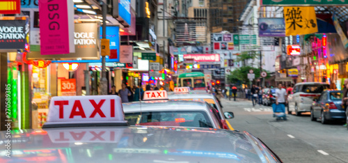 HONG KONG, CHINA - MAY 2014: City taxis and traffic at sunset. Hong Kong attracts 15 million visitors every year © jovannig