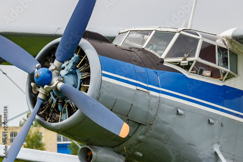 Pilots cabin and engine with four blade propeller of blue and silver soviet biplane aircraft Antonov AN-2
