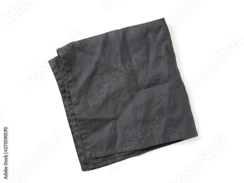 Folded dark black linen napkin isolated on white background. Anthracite grey linen napkin. Isolated on white with clipping path. Top view or flat lay.