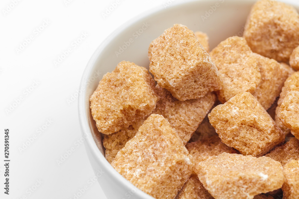 Brown cane sugar cubes isolated on white background Brown cane sugar cubes isolated on white background