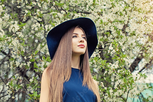 Pretty young woman in blue hat outdoors © artmim