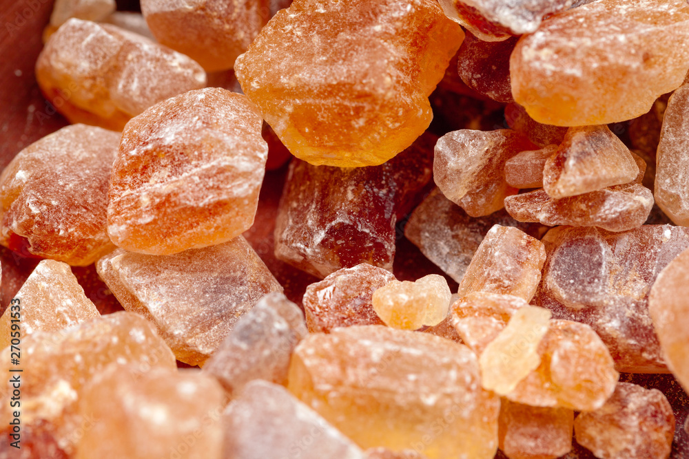 brown sugar rock organic crystalline close up on dark background