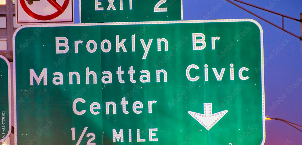 Brooklyn Bridge Manhattan Civic Center sign at night