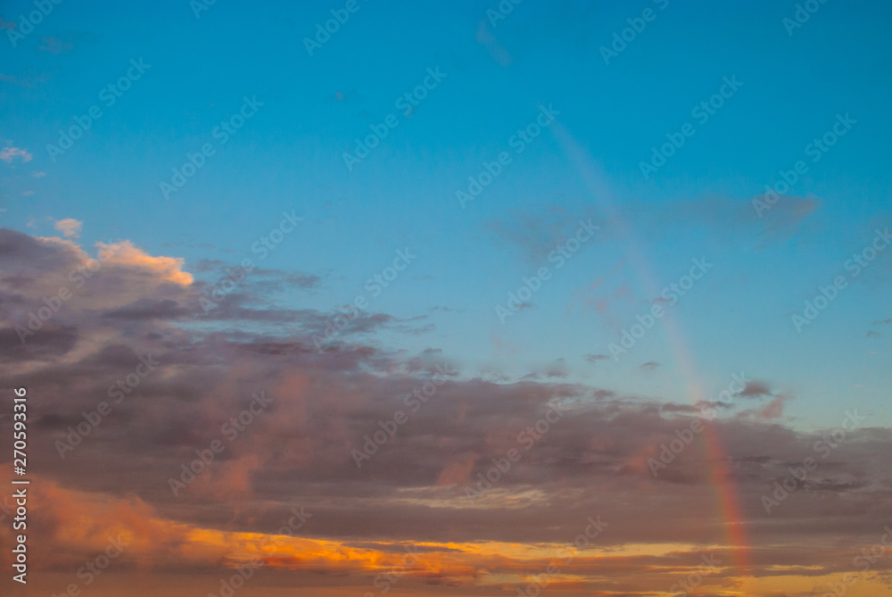 Fototapeta premium faint rainbow at sunset