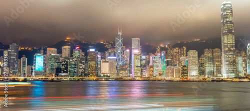 HONG KONG, CHINA - MAY 2014: City skyscrapers from Kowloon at night. Hong Kong attracts 15 million visitors every year