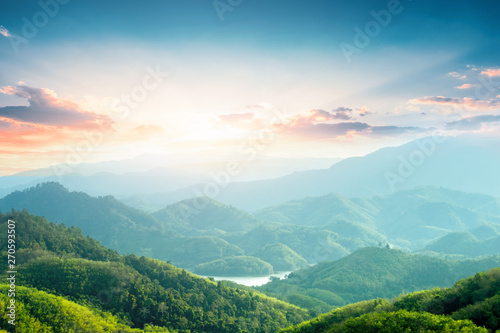 World Environment Day concept: Green mountains and beautiful sky clouds under the blue sky photo