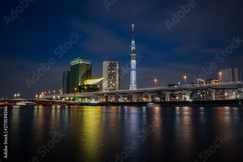 View of the Skytree Tower with the reflection in the river at night. Landscape orientation. © HafizMustapha