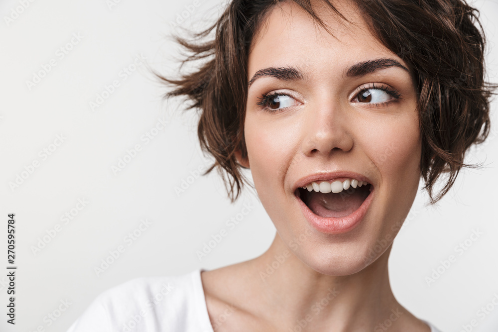 Portrait closeup of cheery woman with short brown hair in basic t-shirt smiling at camera Portrait closeup of cheery woman with short brown hair in basic t-shirt smiling at camera