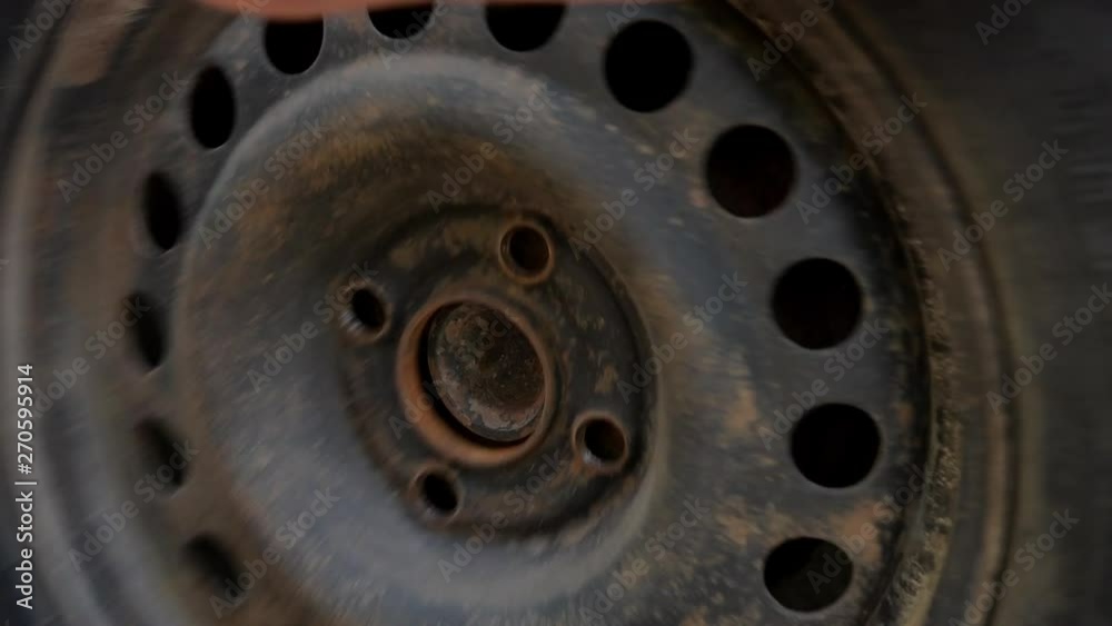 Mechanic removes the wheel from the car. Close-up. Mechanic removes the wheel from the car. Close-up.