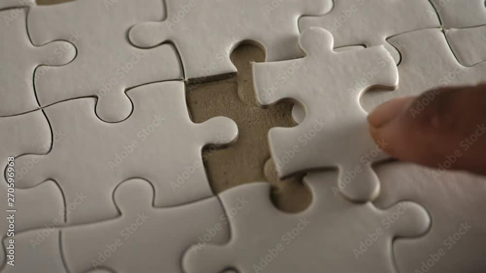 Piece of white jigsaw filling by hand, Success concept Piece of white jigsaw filling by hand, Success concept
