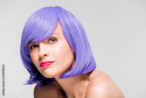 pretty thoughtful girl in purple wig isolated on grey