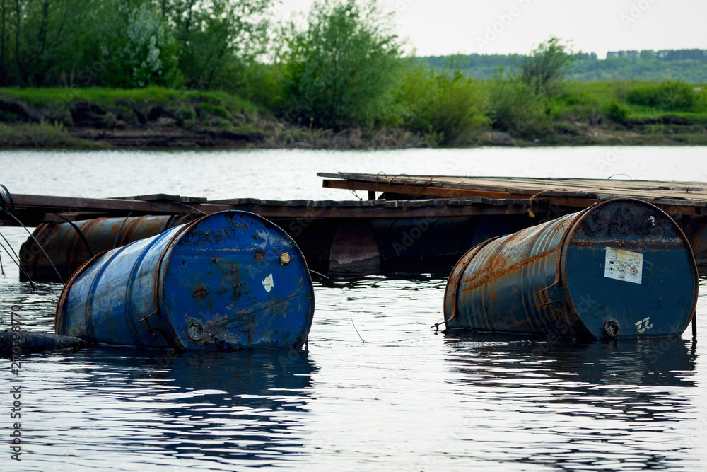 dumped oil drums cause pollution in the water, more and more the water is polluted by throwing away waste which therefore gets into the rivers. Polluted river full of various garbage dumped oil drums cause pollution in the water, more and more the water is polluted by throwing away waste which therefore gets into the rivers. Polluted river full of various garbage