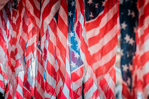 Fototapeta Naklejka Na Ścianę i Meble -  Detail and close up shot of waving american flags. Rippled red and white stripes, patriotism and national pride concept. Natural daylight, warm and cool color tones. 