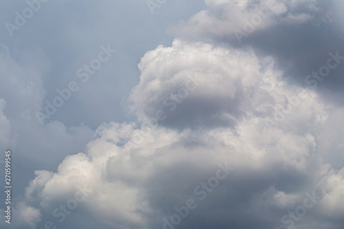 White fluffy clouds in the blue sky background.