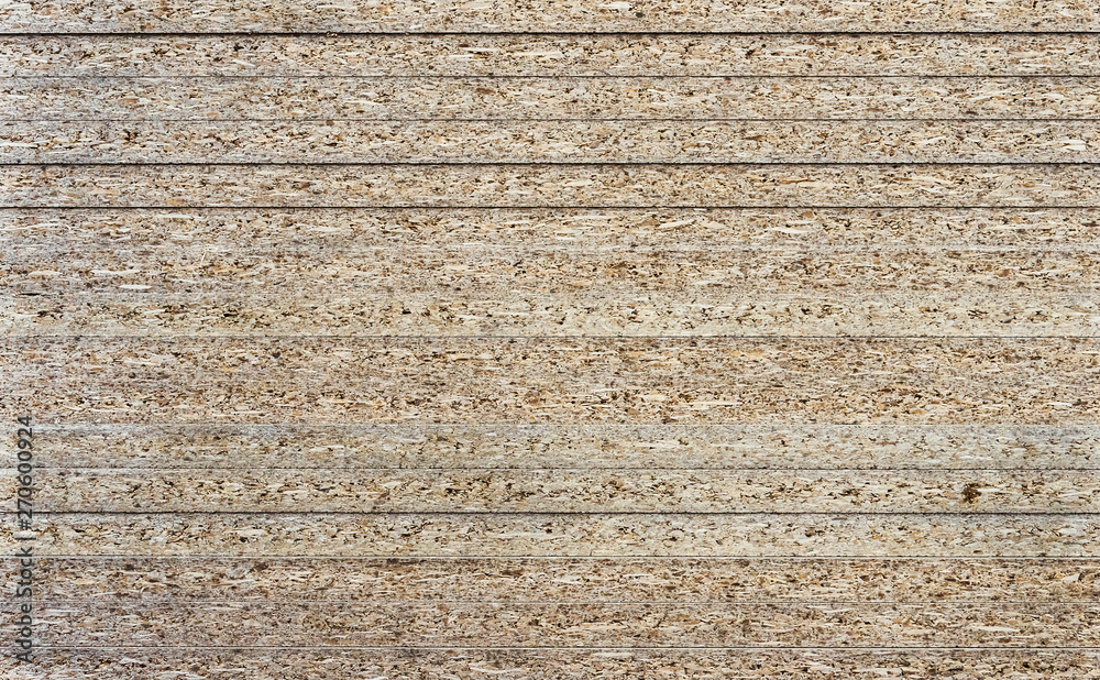 Fototapeta premium Chipboard background. Rough plywood texture. Plate of compressed sawdust.