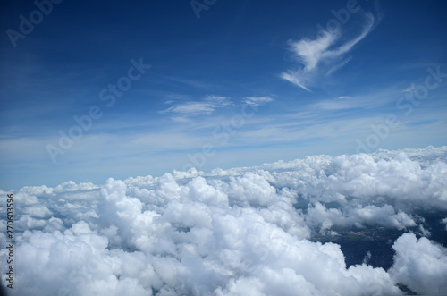 Mid Air clouds cape view through an airplane window
