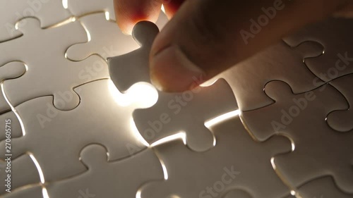 Piece of white jigsaw filling by hand, Success concept