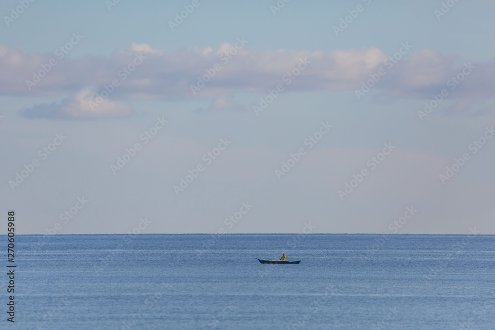 fisherman in the blue sea with blue sky and white clouds and copy space a tranquil seascape scene fisherman in the blue sea with blue sky and white clouds and copy space a tranquil seascape scene