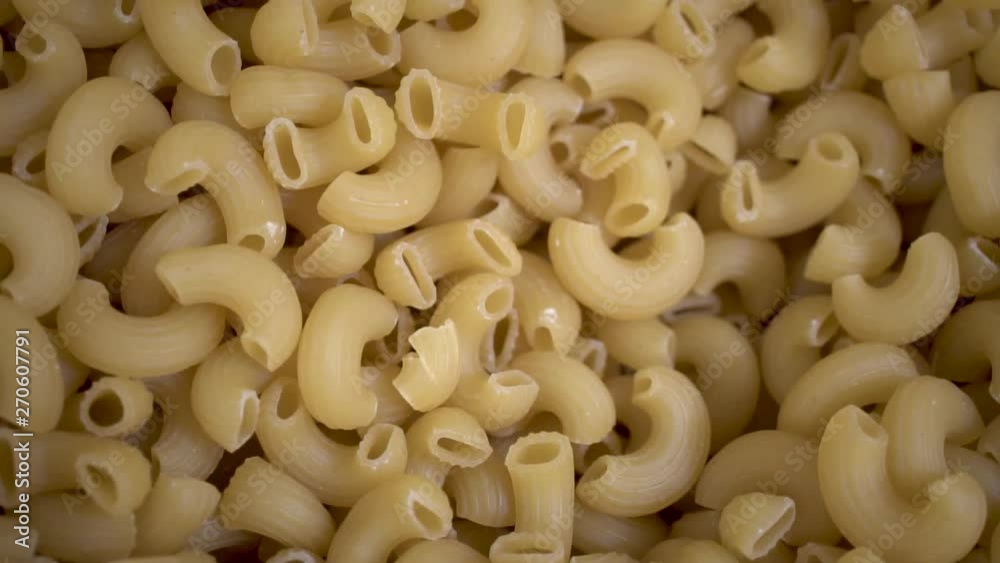 Close Up, Uncooked elbow macaroni noodles in bulk, isolated Close Up, Uncooked elbow macaroni noodles in bulk, isolated