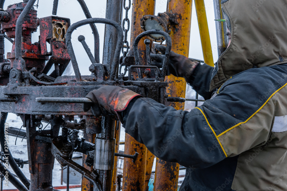 Workover rig working on a previously drilled well trying to restore production through repair. Toned. Workover rig working on a previously drilled well trying to restore production through repair. Toned.