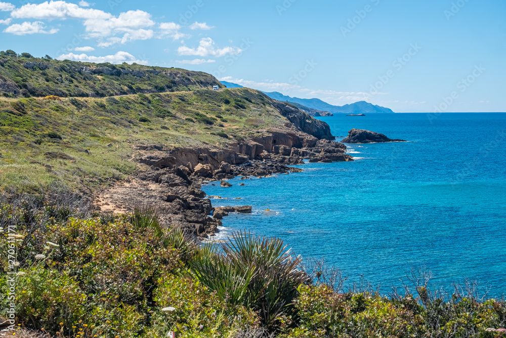 Spectacular landscapes, awe-inspiring cliffs, charming villages and historical landmarks along the coastal road between Alghero and Bossa (SP 105), Sardinia, Italy